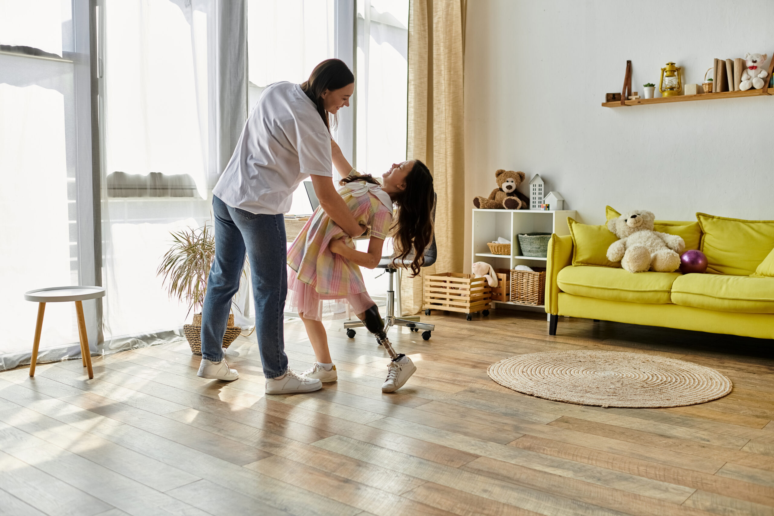 A mother and her daughter, who has a prosthetic leg, share a joyful moment of play at home.