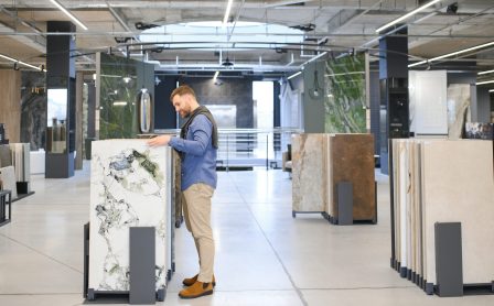 Middle age man choosing ceramic tiles and utensils for his home bathroom.