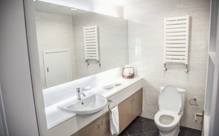 Modern, clean, bathroom with toilet and sink.